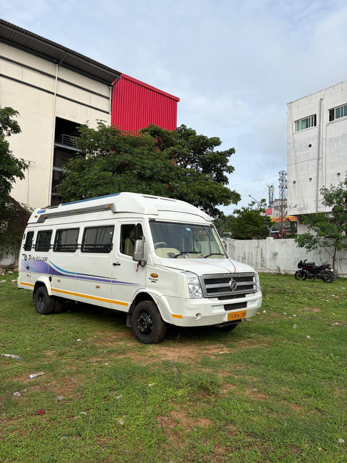 White Tempo Traveller parked on grass