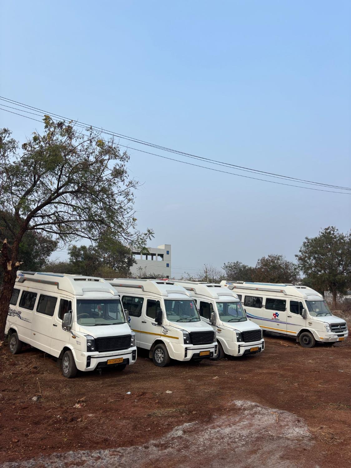 A row of white Tempo Travellers